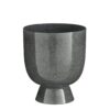 James Bloempot op Standaard H22 x Ø19 cm Metaal - Grijs  De James bloempot is een moderne klassieker die perfect past in ieder interieur, van industrieel tot modern of minimalistisch! De James bloempot op voet heeft een stoere grijze kleur en brengt een subtiele, maar stijlvolle touche in je woonkamer, slaapkamer of kantoorruimte. Het materiaal van de James bloempot is metaal, wat hem erg stevig maakt. De metalen bloempot heeft een hoogte van 22 cm en een diameter van 19 cm. Perfect voor al je prachtige groen! Breedte: 19cm Hoogte: 22cm Lengte: 19cm Diameter: 19cm Gewicht: 1560g kleuren: Grijs Materialen: Ijzer merk: Mica Decorations