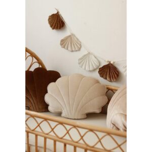 Fluwelen schelpkussen 'Cream Pearl' Fantastisch voor zowel volwassenen als kinderen, want als je even wilt uitrusten of een dutje wilt doen, kun je dat het beste op een zacht, fluweelachtig kussen doen. Dat weet iedereen! Sierkussens  zijn mooi, zeer comfortabel en praktisch. Ze vormen een mooie decoratie van de kinderkamer, maken het uiterst gezellig en creëren perfecte omstandigheden voor dutjes en  uiteraard  spelen! Omdat het zo spectaculair is, benadrukt het zowel verfijnde woonkamers als gezellige kinderkamers. Elk interieur wordt prachtig met onze bestverkochte collectie van glanzend, zacht fluweel. Of het nu in je woonkamer is, als decoratie voor een kinderbedje of een rotan fauteuil: C’est chic! Maak uw eigen kussencomposities van de beschikbare patronen! Een prachtig fluwelen schelpvormig kussen, zorgvuldig genaaid van hoogwaardige crèmekleurige fluwelen stof met elastaan ​​dat prachtig ligt en glanst. Superzacht om aan te raken, voor de slaapkamer en de woonkamer. Gevuld met hoogwaardige anti-allergische siliconenvezelbolletjes. Je kunt hem veilig wassen in de wasmachine, de vulling blijft luchtig en elastisch. Stof: 95% polyester, 5% elastaan, 330 g Afmetingen: 47 cm x 42 cm. Wastemperatuur: tot 30°C. Casa & Viventes kleuren: Wit Materialen: Polyester, Elastaan, Schelp, Fluweel merk: Moi Mili